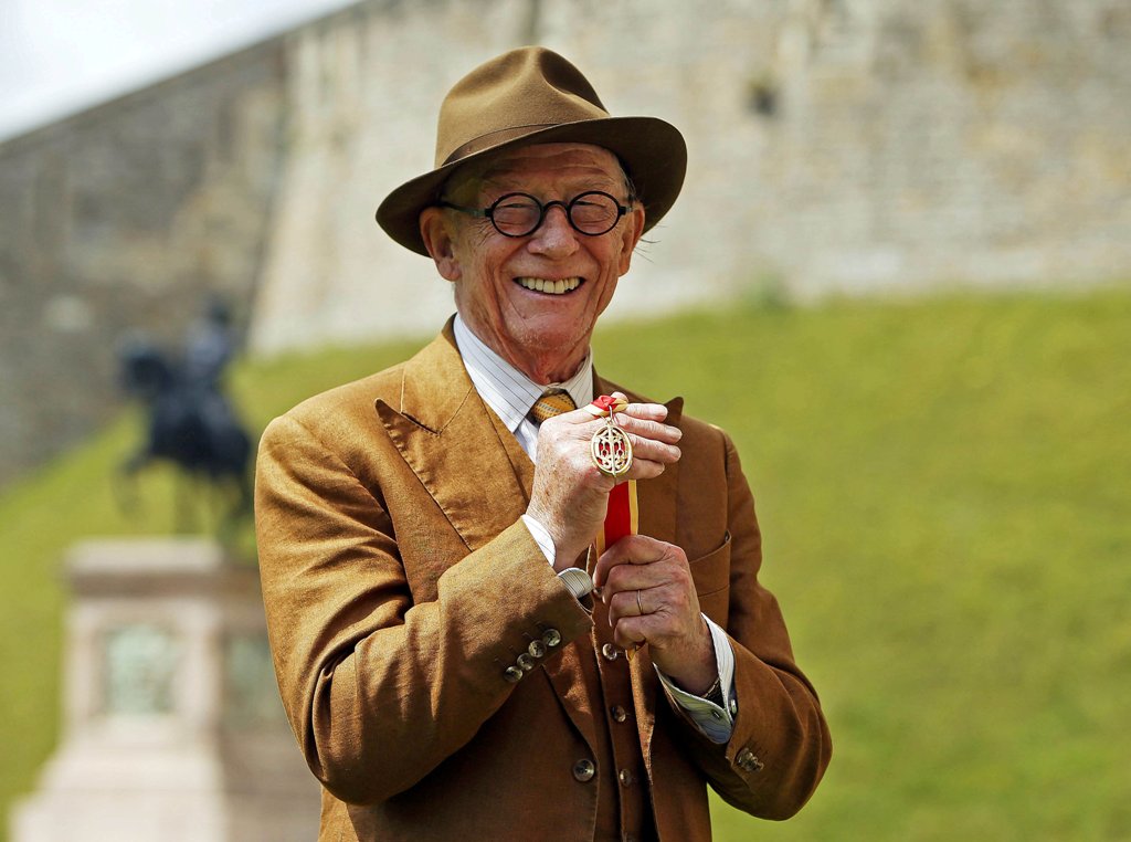  British actor John Hurt poses with his award after receiving a knighthood by Queen Elizabeth during an investiture ceremony at Windsor Castle in Windsor, Britain July 17, 2015. REUTERS/Steve Parsons/pool/File photo
