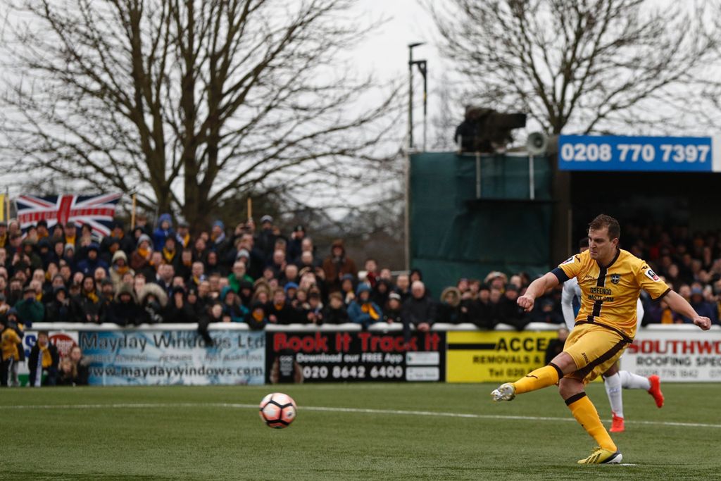 Sutton United's English defender Jamie Collins scores the opening goal from the penalty spot during the English FA Cup fourth round football match between Sutton United and Leeds United at the Borough Sports Ground in London on January 29, 2017.  AFP / Ad