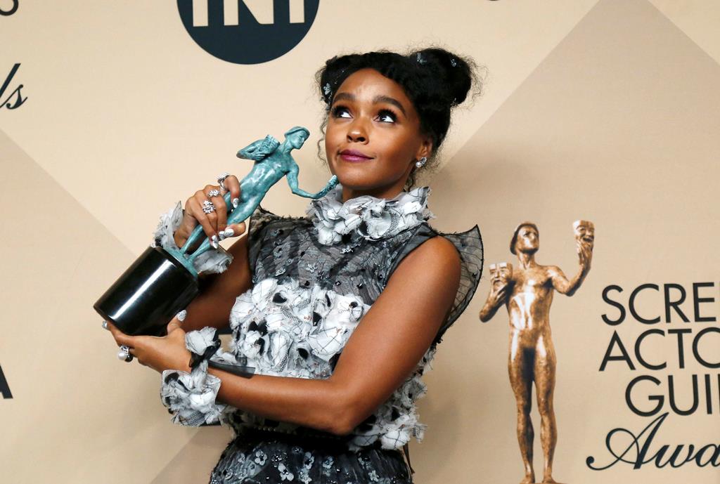 Actress Janelle Monae poses backstage with her award for Outstanding Performance by a Cast in a Motion Picture for 