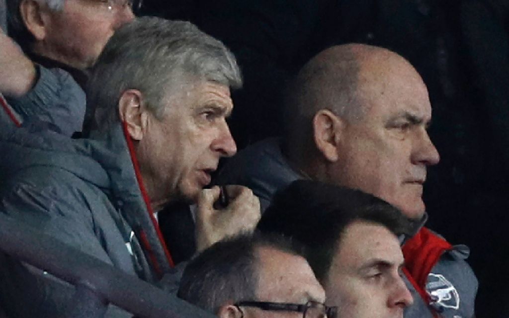 Arsenal's French manager Arsene Wenger (L) gives instructions to the dugout from the director's box during the English FA Cup fourth round football match between Southampton and Arsenal at St Mary's in Southampton, southern England on January 28, 2017. / 