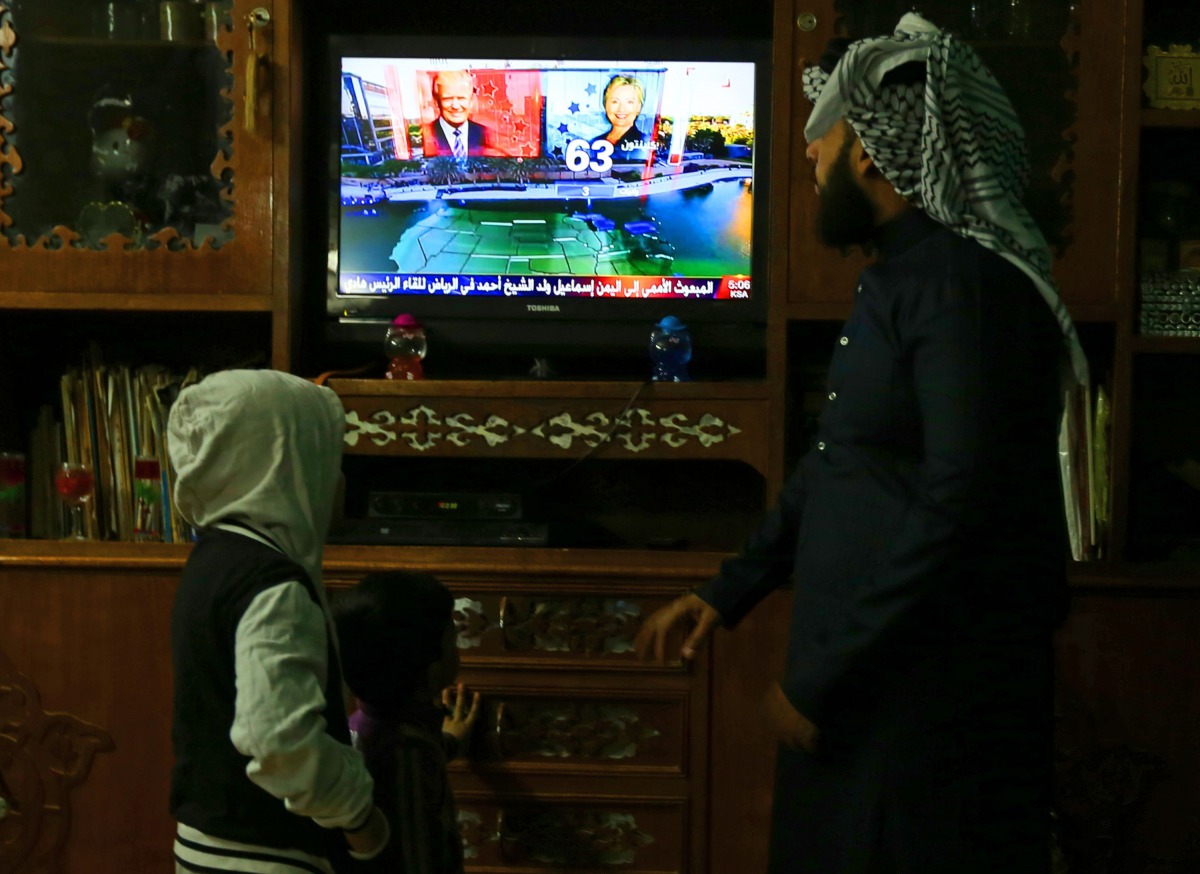 FILE PHOTO: An Iraqi family follows the US presidential elections on television at their home in Baghdad on November 8, 2016 (AFP) 