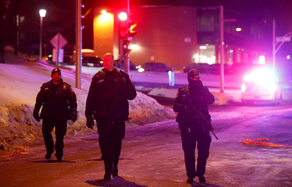 Police officers patrol the perimeter near a mosque after a shooting in Quebec City, January 29, 2017. REUTERS/Mathieu Belanger.