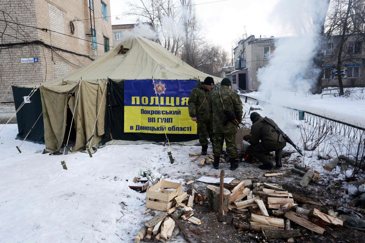 Ukrainian servicemen set tents and make fires to warm local residents of town of Avdiivka (about 20,000 people),Donetsk region after the the town's heating is provided by a coke plant that has been heavily damaged by the falling shells on January 2017. Uk