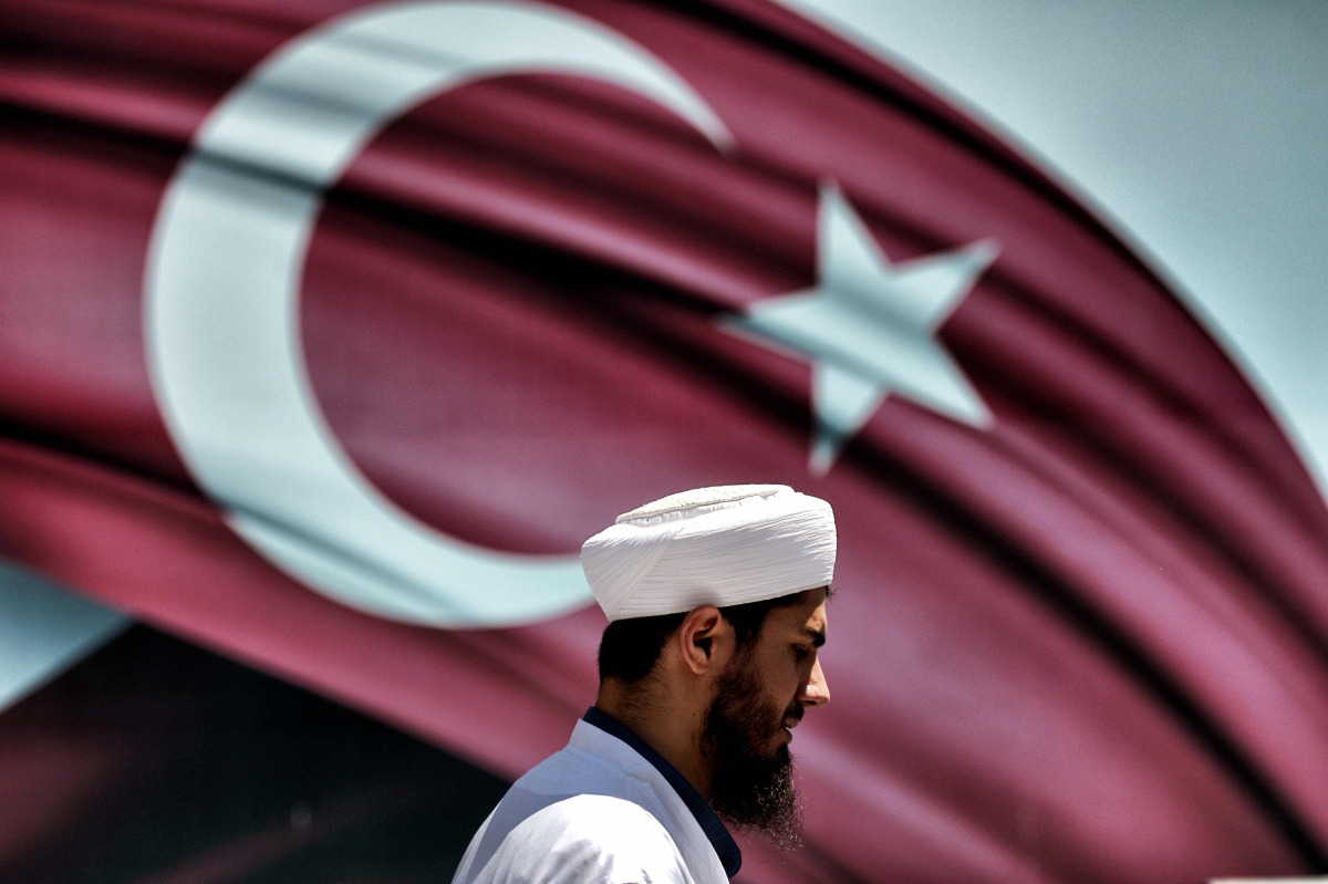 A man passes the Turkish at the Sarachane park in Istanbul on July 19, 2016. AFP