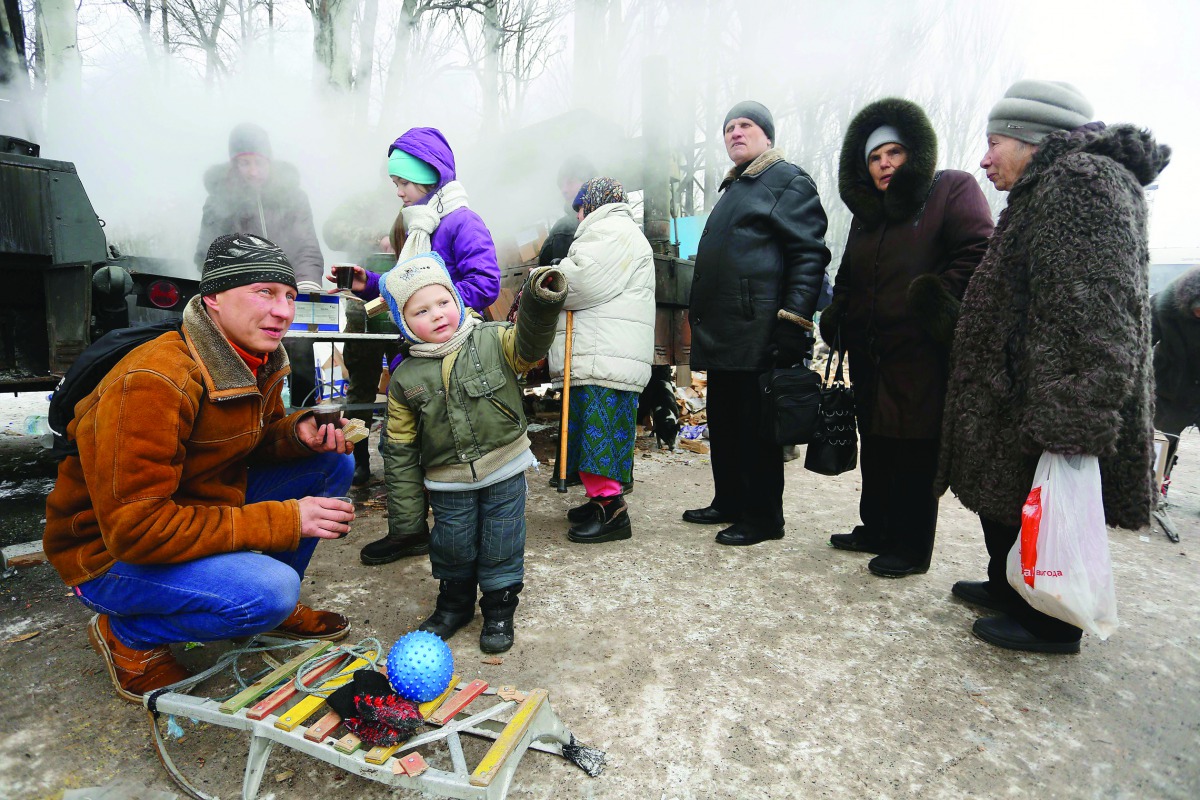 Residents queue for hot food distributed by Ukrainian rescue services in the flashpoint eastern town of Avdiivka, yesterday.