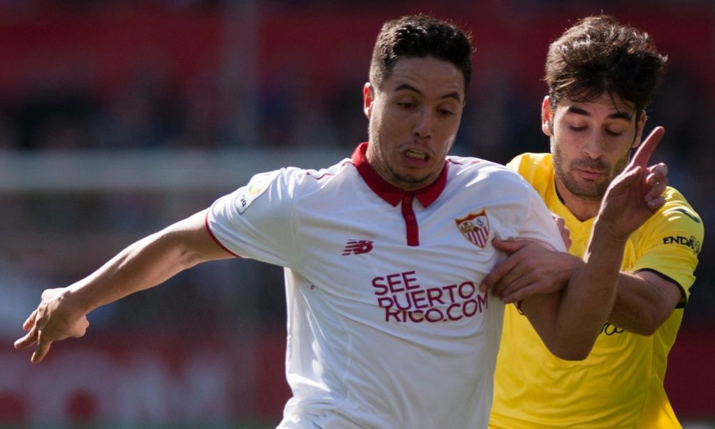Sevilla's French forward Samir Nasri (L) vies with Villarreal's midfielder Manuel Trigueros during the Spanish league football match Sevilla FC vs Villarreal CF at the Ramon Sanchez Pizjuan stadium in Sevilla on February 5, 2017. / AFP / JORGE GUERRERO