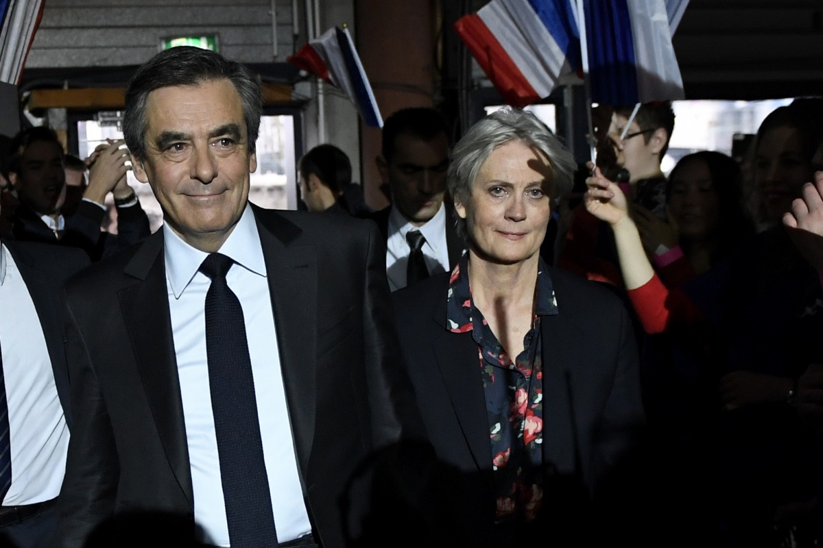 Francois Fillon, former French prime minister, member of The Republicans political party and 2017 presidential candidate of the French centre-right, arrives with his wife Penelope Fillon (R) to attend a political rally in Paris, France, January 29, 2017. 