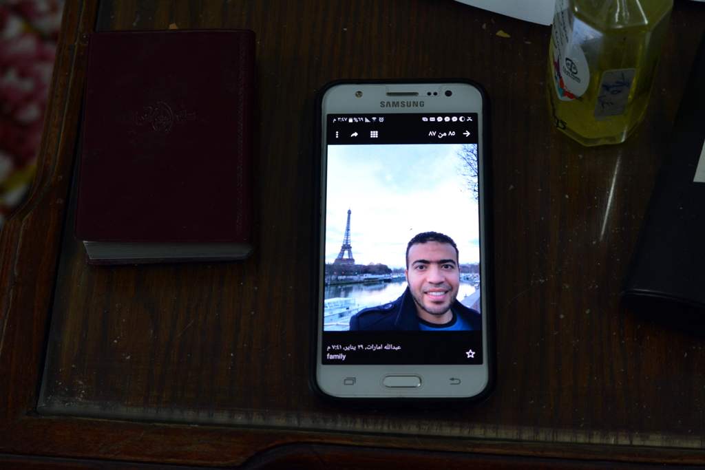 A picture taken on February 5, 2017, shows a picture of Abdallah El-Hamahmy, an Egyptian suspected of being the machete attacker in Paris's Louvre museum, displayed on a phone at the family home in the Nile delta city of Mansura, some 120 kms north of Cai