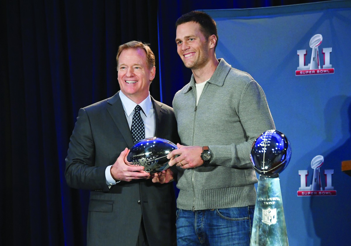 NFL Commissioner Roger Goodell (left) presents Tom Brady with the Pete Rozelle Trophy for Most Valuable Player in Houston on Monday.