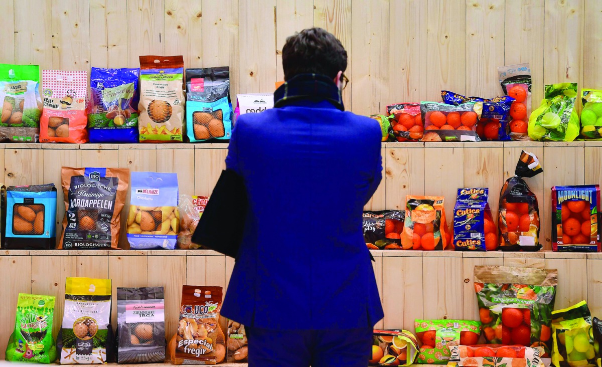 A visitor looks at a presentation shelf during the opening day of the 