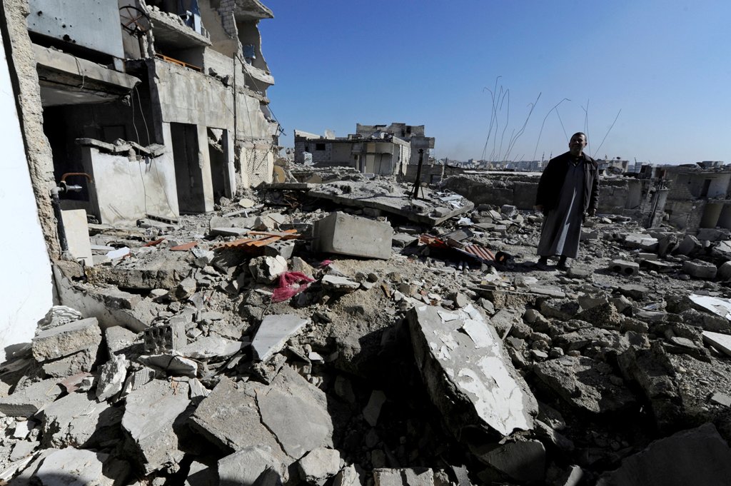 Eymad, 54, stands on the rubble of the damaged rooftop of his house at al-Mouassassi street in Aleppo, Syria, February 2, 2017. REUTERS/Omar Sanadiki
