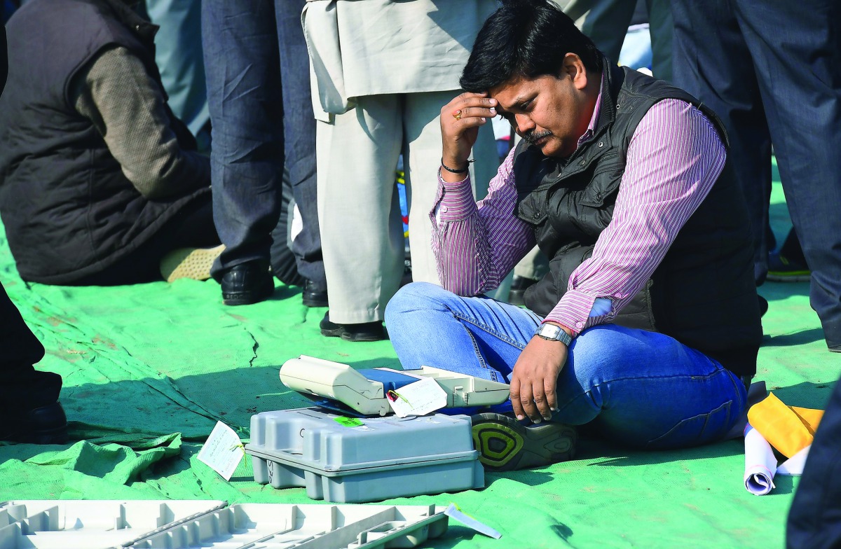 An election official checks an Electronic Voting Machines at a distribution centre in Ghaziabad yesterday.
