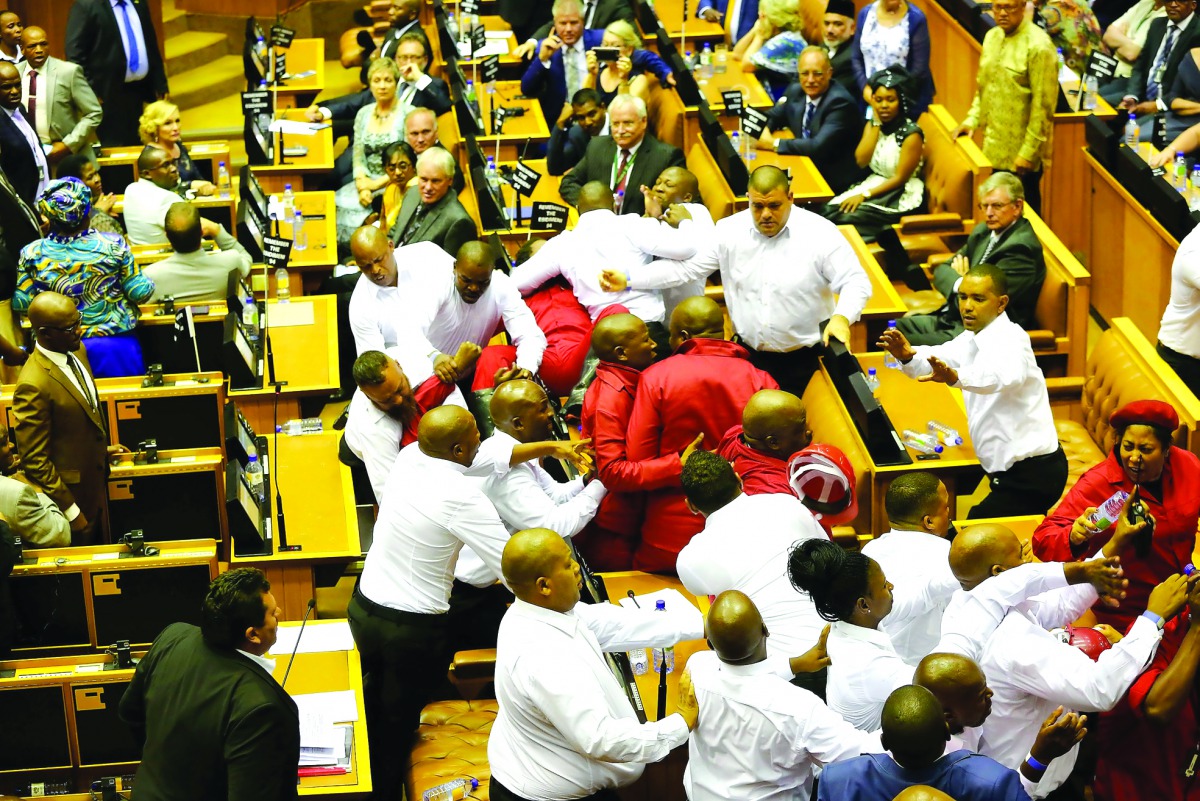 Security officials force out South African opposition party Economic Freedom Fighters members during South African President's speech for the State Of the Nation Address in Cape Town.