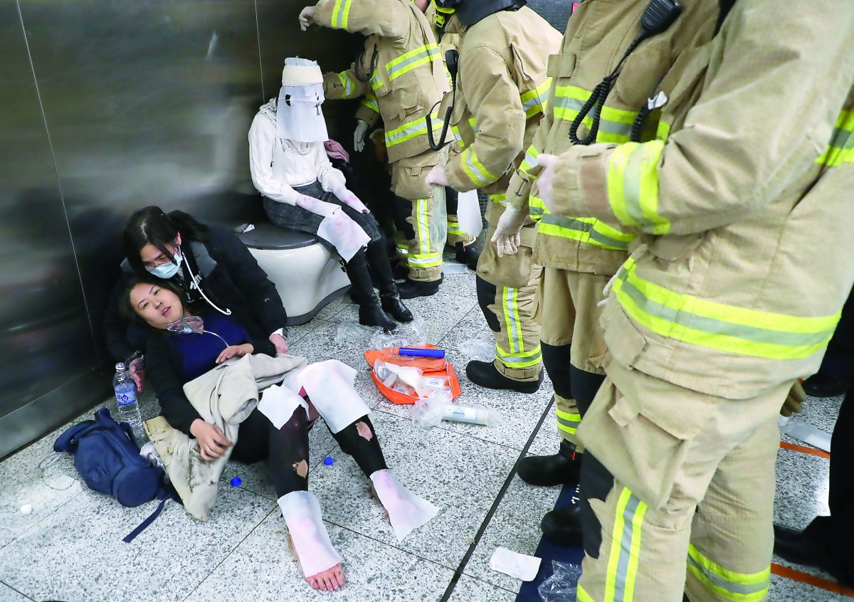 Injured people undergoing medical treatment inside a subway station in Hong Kong, yesterday.