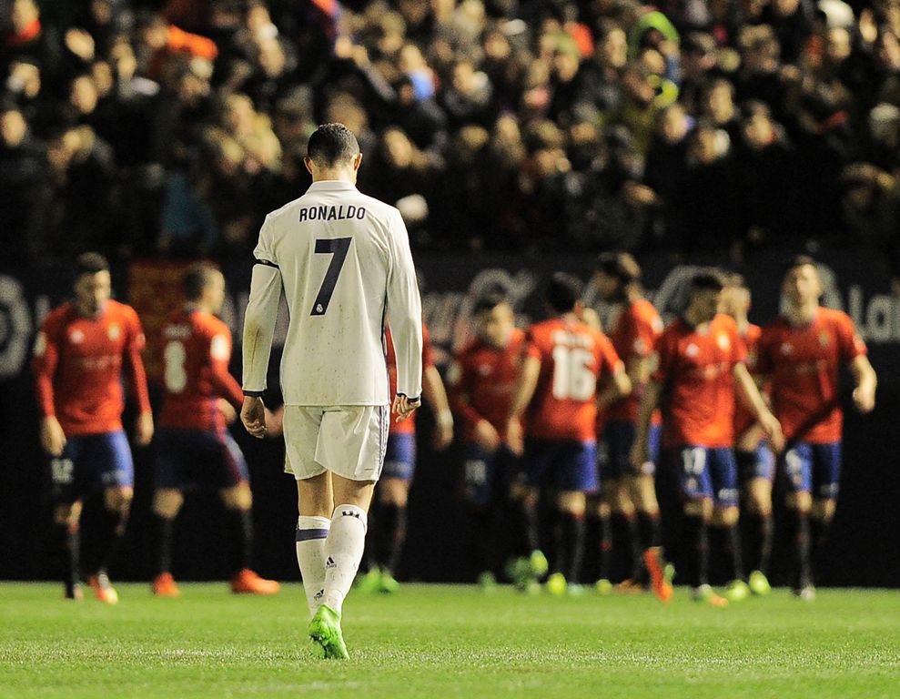 TOPSHOT - Real Madrid's Portuguese forward Cristiano Ronaldo walks after a goal by Osasuna during the Spanish league football match CA Osasuna vs Real Madrid CF at El Sadar stadium in Pamplona on February 11, 2017. / AFP / ANDER GILLENEA
