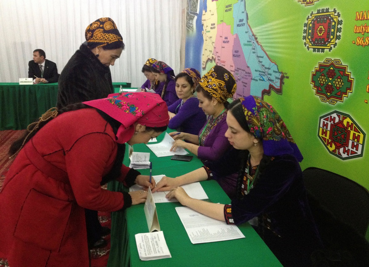 A woman signs to collect her ballot during a presidential election at a polling station in Ashgabat, Turkmenistan, February 12, 2017. REUTERS/Marat Gurt