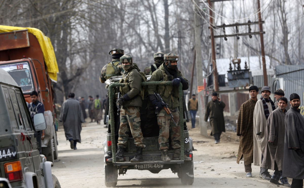 Indian paramilitary soldiers travel in a vehicle after a gunbattle in Hajin, some 38 kilometres (23.75 miles) north-east of Srinagar on February 14, 2017. Three soldiers and a suspected militant were killed in a gunbattle in Indian-administered Kashmir, a