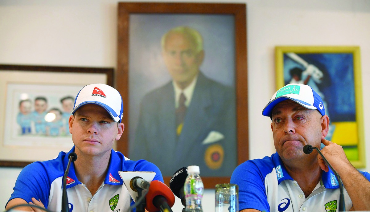 Australia's Test cricket captain Steven Smith (left) and head coach Darren Lehmann listen to a question during a press conference in Mumbai yesterday. 