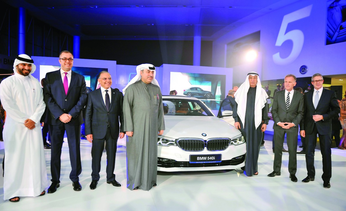 Hussain Ibrahim Alfardan (third right) Chairman AlFardan Group,  Omar Hussain Alfardan, President and CEO of AlFardan group (fourth left) with other officials and guests on the launch of BMW 5 Series at BMW Alfardan showroom in West Bay. Pic: Abdul Basit/