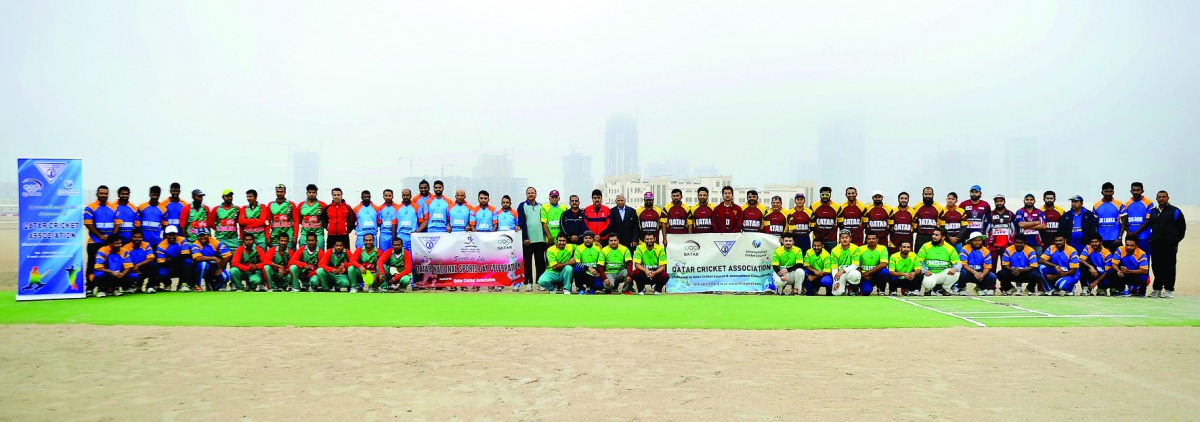 Participating teams of a cricket tournament poses for a group photo at West Bay Ground. The Qatar Cricket Association (QCA) organised the event to celebrate the National Sport Day. QCA Board President Yousef Jeham Al Kuwari inaugurated the tournament. Pic