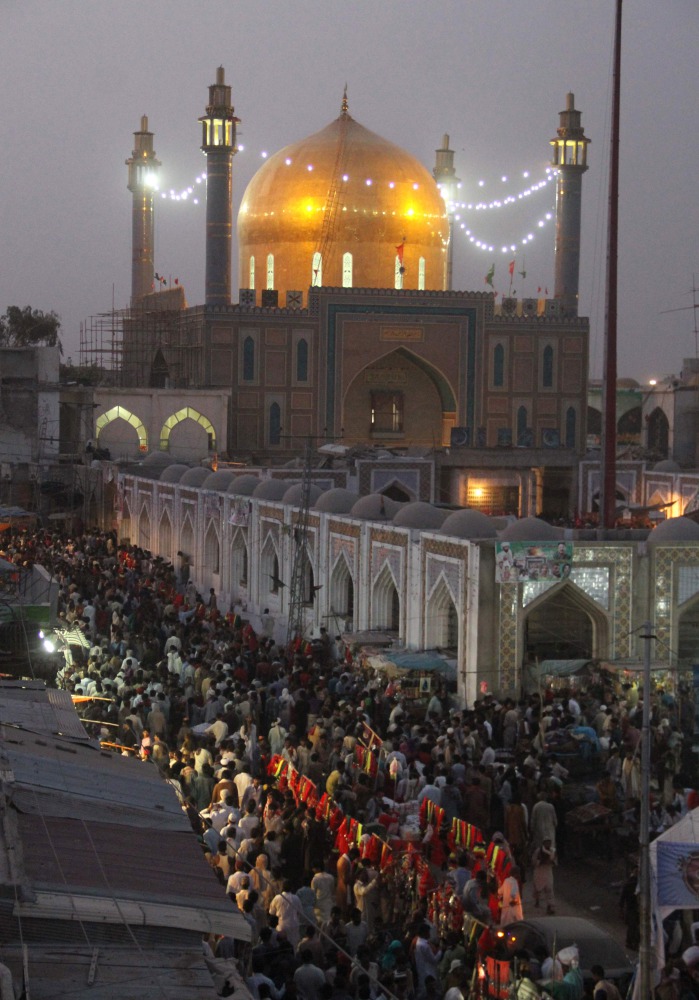 In this photograph taken on June 18, 2014, Pakistani devotees gather at the shrine of 13th century Muslim Sufi saint Lal Shahbaz Qalandar in Sehwan, some 200 kilometres (124 miles) northeast of Karachi. (AFP / YOUSUF NAGORI)