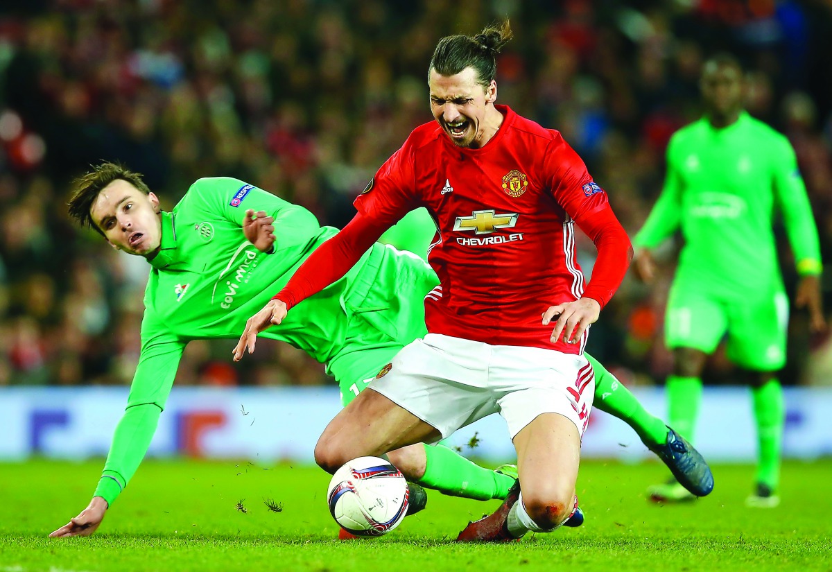 Manchester United's Swedish striker Zlatan Ibrahimovic is fouled by St Etienne's Ole during the UEFA Europa League Round of 32 first-leg match against Saint-Etienne at Old Trafford Stadium in Manchester, north-west England, on Thursday.