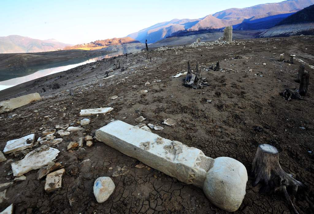 This picture taken on February 16, 2017, shows a the ruins of a sunken mosque and nearby graveyards as evidence of human habitation in the past on the dried-out lake bed of artificial Ramsko lake near the Bosnian town of Prozor, some 120 km west of Saraje