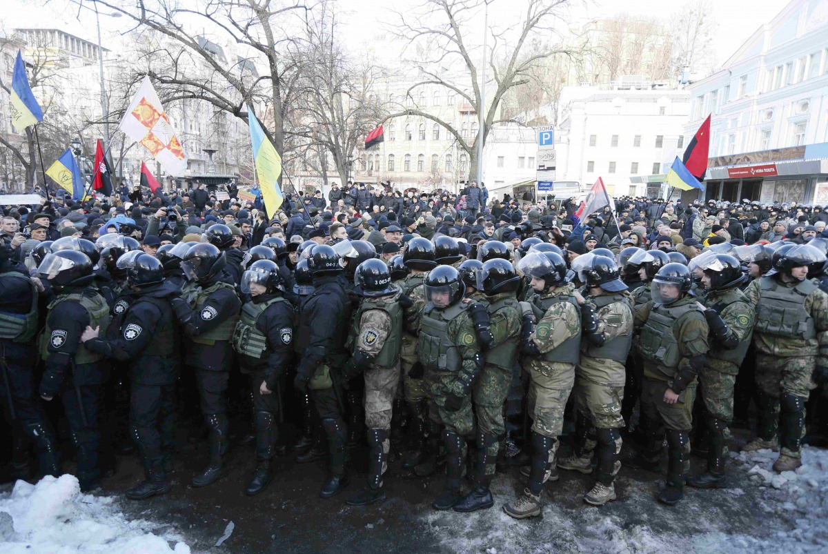 Riot police and members of the Ukrainian National Guard block activists and supporters of nationalist parties during a rally against trade with Ukraine's rebel-held east areas in Donetsk and Luhansk regions, in Kiev, Ukraine February 19, 2017. REUTERS/Val