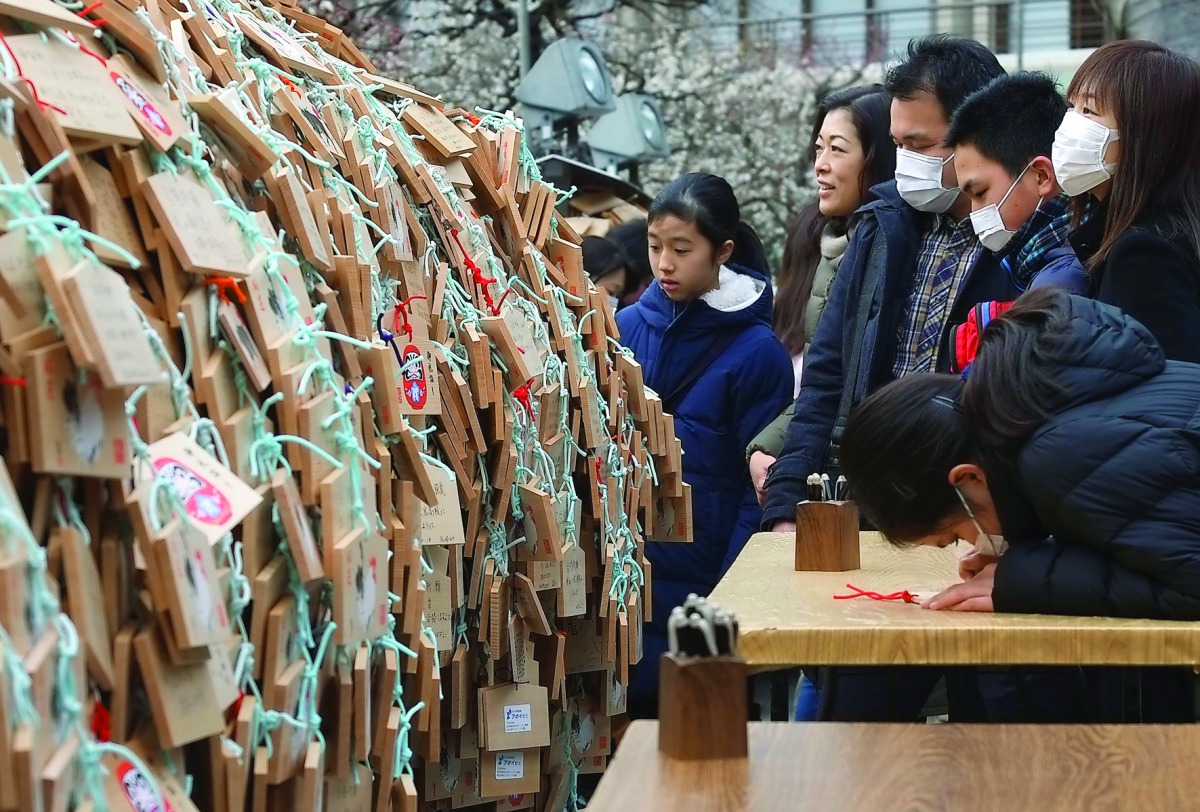 A large number of Ema, wooden votive tablets with wishes on them, are seen at Yushima Tenmangu Shrine in Tokyo on February 18, 2017. Throngs of students and their parents come to the shrine to pray for their educational success as the annual school entran