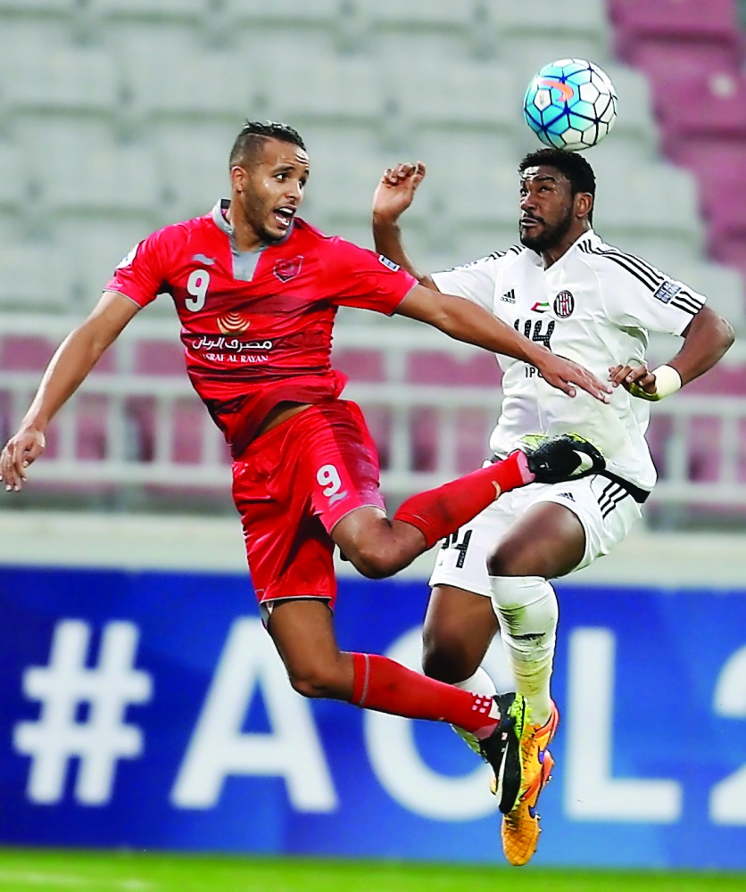 Youssef El Arabi (left) of Lekhwiya is locked in an aerial battle with an Al Jazira player during the AFC Champions League Group B opener at Abdullah Bin Khalifa Stadium in Doha yesterday. Lekhwiya won 3-0. 
