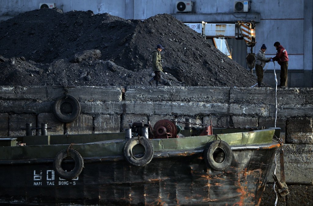 Coal laborers in 2013 in the North Korean town of Sinuiju, which is close to the Chinese city of Dandong. Credit Mark Ralston/Agence France-Presse.