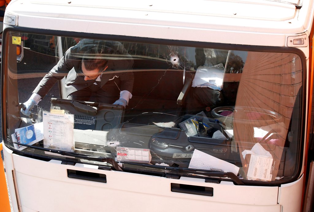 An investigator is seen inside a gas cylinder delivery truck with bullet holes in its windscreen after police fired shots to stop the driver, whom they say had stolen the truck and was driving against traffic, in Barcelona, Spain, February 21, 2017. REUTE