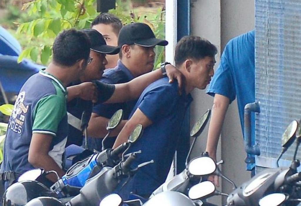 A North Korean man (R) identified by the Malaysian police as Ri Jong Chol and suspected by the authorities to be in connection with the murder of Kim Jong Nam, is taken to a police station in Sepang, Malaysia, February 18, 2017. Park Jung-ho/News1 via REU
