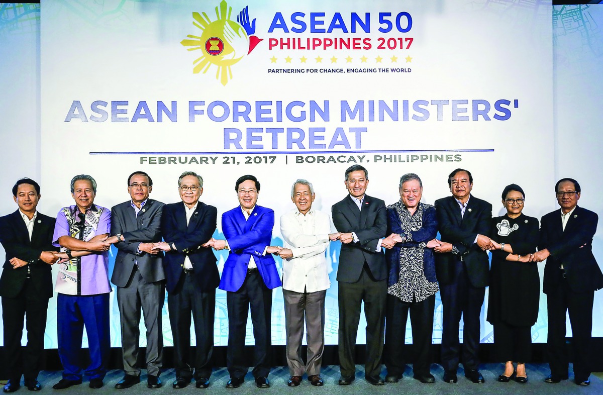 Association of South East Asian Nations (Asean) Foreign Ministers link arms during the retreat in Boracay, central Philippines, yesterday. 