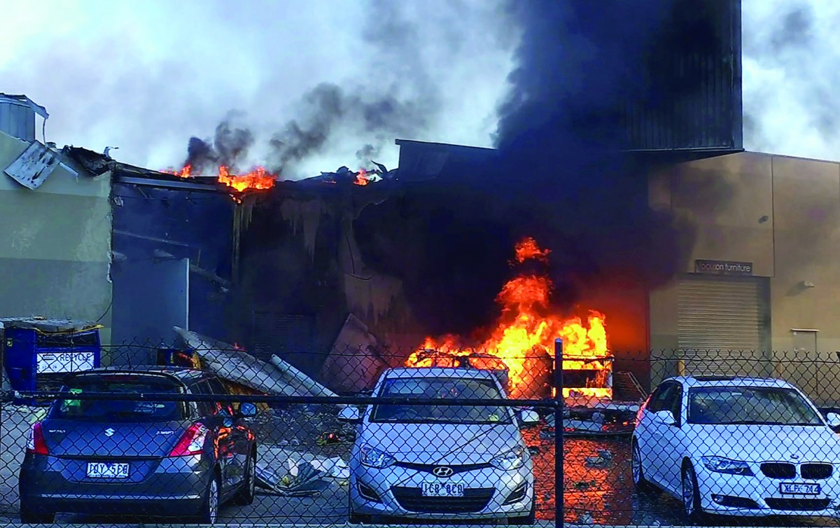 Smoke and flames seen after a twin-engined Beechcraft plane crashed into a shopping centre just after take-off from Essendon Fields Airport near Melbourne, yesterday.