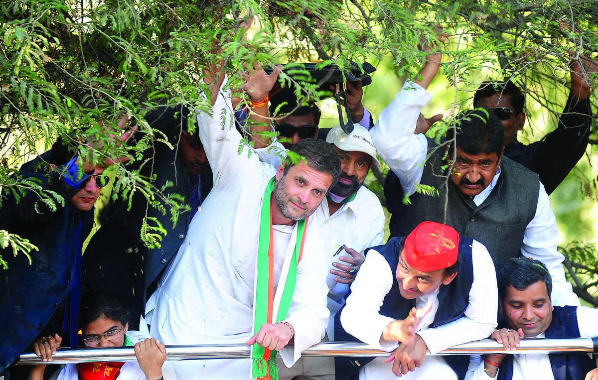 Chief Minister of the northern Indian state of Uttar Pradesh and Samajwadi Party leader Akhilesh Yadav (second right) and Congress Vice-President Rahul Gandhi (centre) pass under foliage as they take part in a joint roadshow in support of their state asse