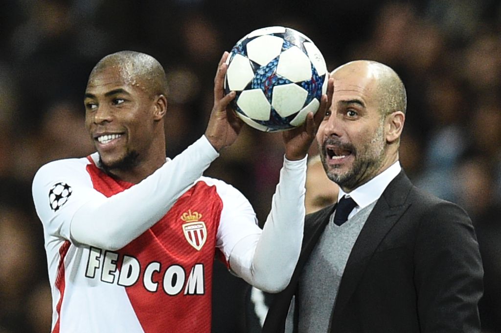 Manchester City's Spanish manager Pep Guardiola (R) reacts with Monaco's French defender Djibril Sidibe (L) during the UEFA Champions League Round of 16 first-leg football match between Manchester City and Monaco at the Etihad Stadium in Manchester, north
