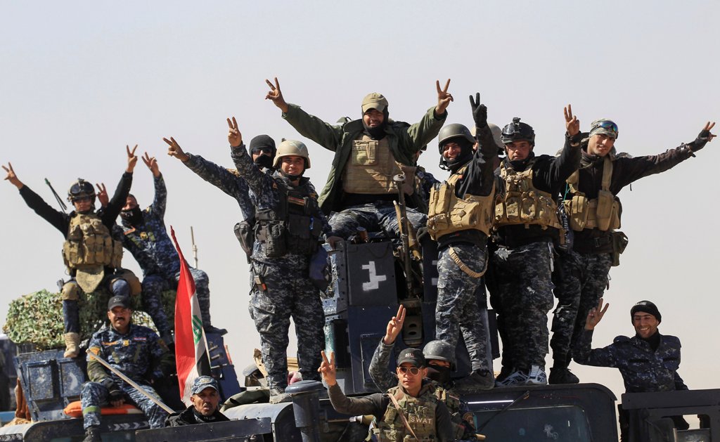 Members of the federal police react as they arrive in Albu Saif, which was recently retaken by Iraqi military forces, south of Mosul, Iraq February 22, 2017. REUTERS/Zohra Bensemra
