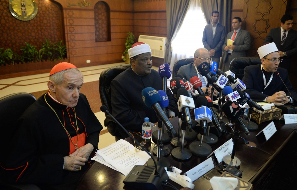 A representative from the Vatican French cardinal Jean-Louis Tauran (L), president of the Pontifical Council for Interreligious Dialogue in the Roman Curia, and Abbas Shuman (2nd-L), deputy imam of Cairo's al-Azhar mosque, attend a joint seminar in Cairo 