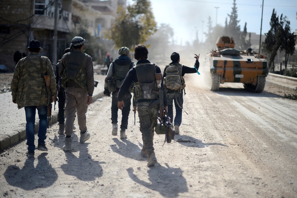 Free Syrian Army members move forward to the center of Al-Bab district during the 