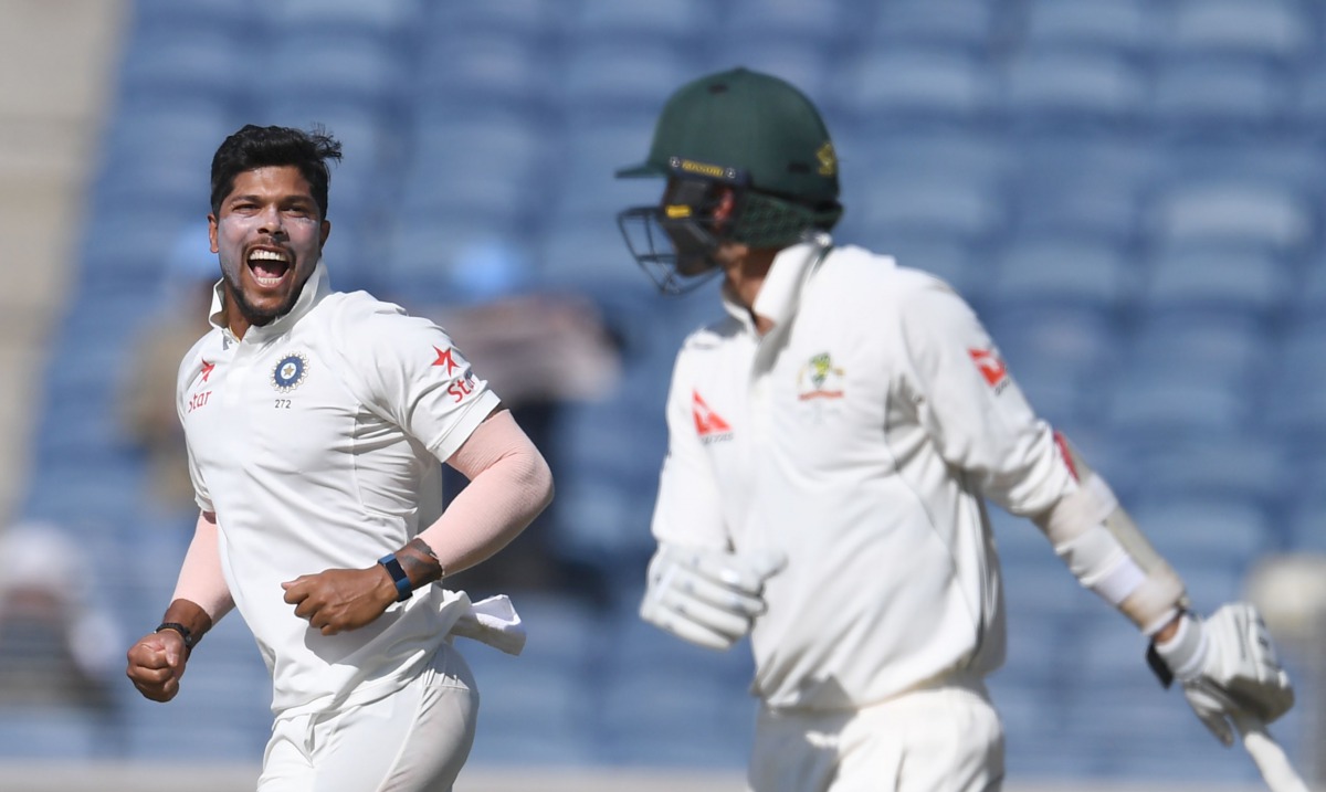 India's Umesh Yadav (L) celebrates after the dismissal of Australia's Nathan Lyon (R) on the first day of the first Test cricket match between India and Australia at the Maharashtra Cricket Association stadium in Pune on February 23, 2017. (AFP / INDRANIL