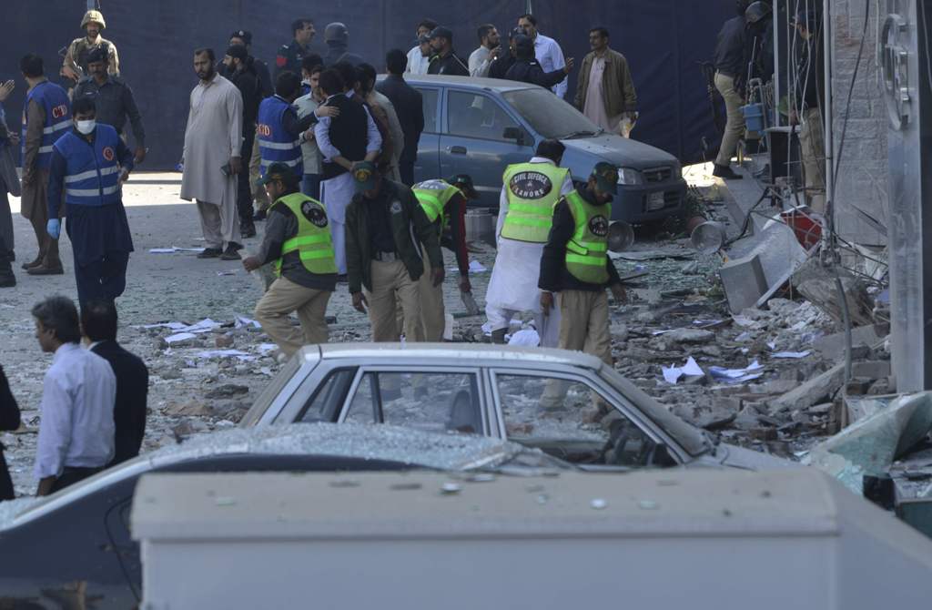 Pakistani security officials examine the site after a bomb attack in Lahore on February 23, 2017.   AFP / ARIF ALI
