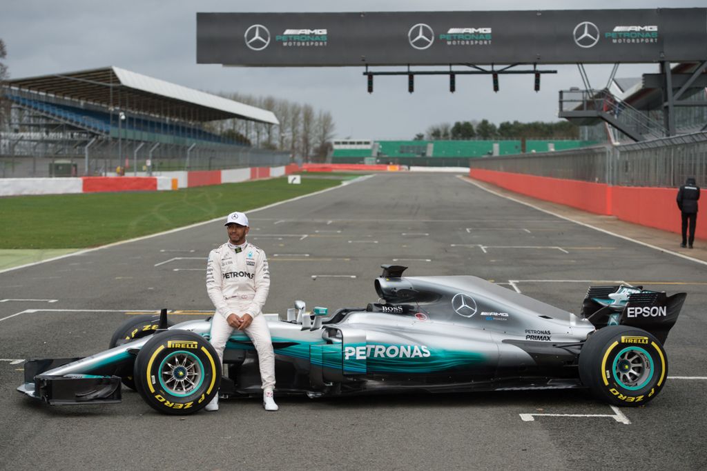 Mercedes AMG Petronas Formula One driver Britain's Lewis Hamilton poses by the new 2017 season Mercedes W08 EQ Power+ Formula One car at its launch event at Silverstone motor racing circuit near Towcester, central England on February 23, 2017. / AFP / OLI
