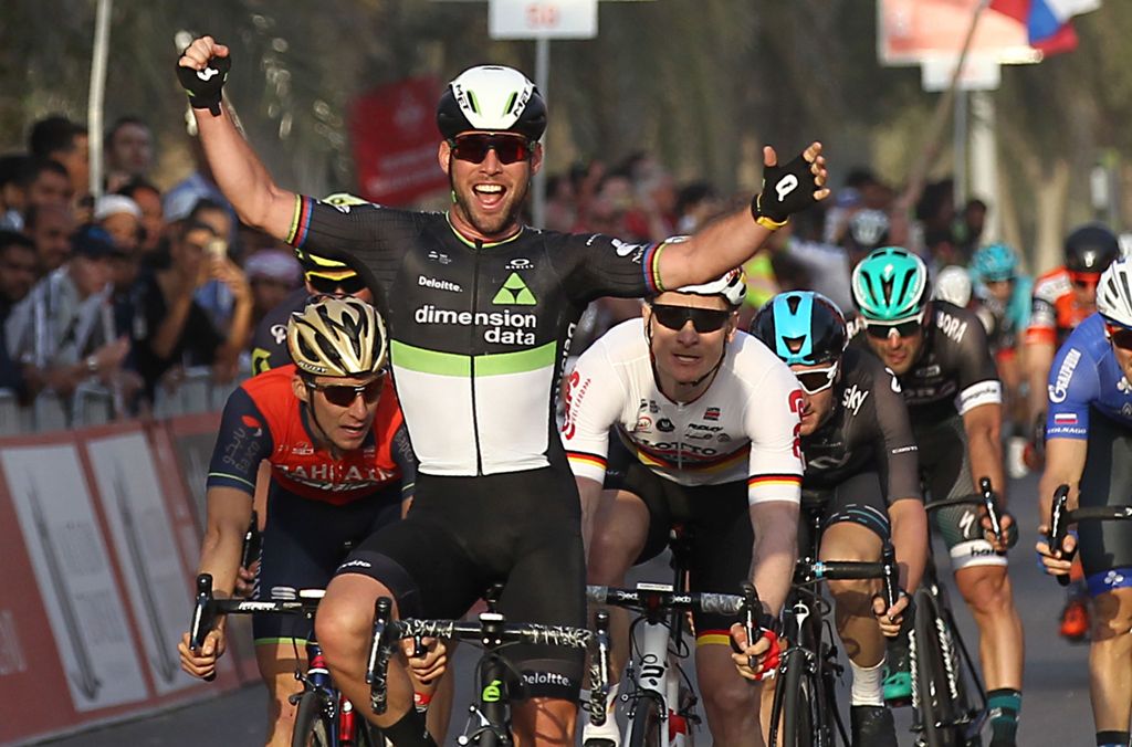 Mark Cavendish from Dimension Data team celebrates as he crosses the finish line in Madinat Zayed to win the opening stage of the 2017 Abu Dhabi Tour on February 23, 2017. / AFP / NEZAR BALOUT
