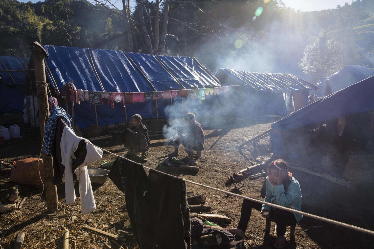 This file photo taken on January 21, 2017 shows refugees in front of their temporary shelter near Lung Byeng village, Waimaw township in Kachin state. The head of Myanmar's most powerful ethnic rebel group has warned that fighting in the country's restive