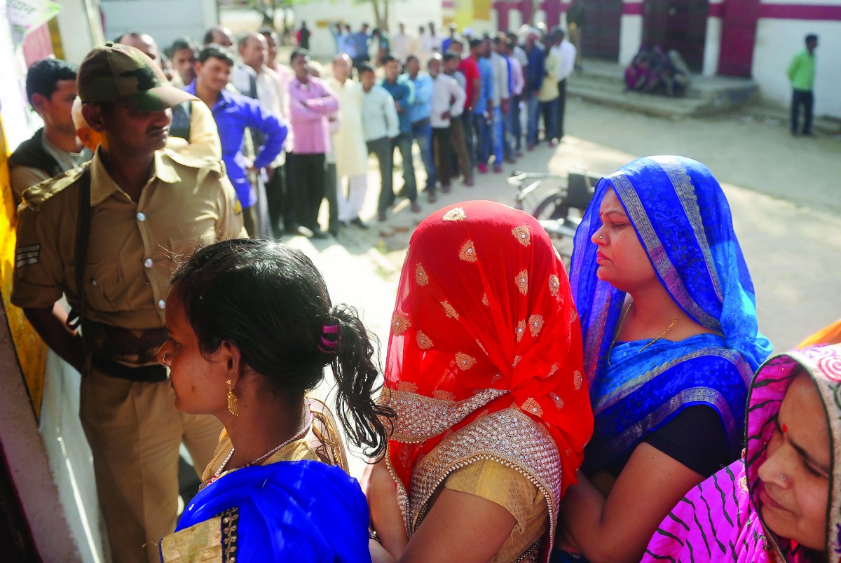 People wait for their turn to vote at a polling station in the Naini area on the outskirts of Allahabad during the fourth phase of Uttar Pradesh assembly elections, yesterday.