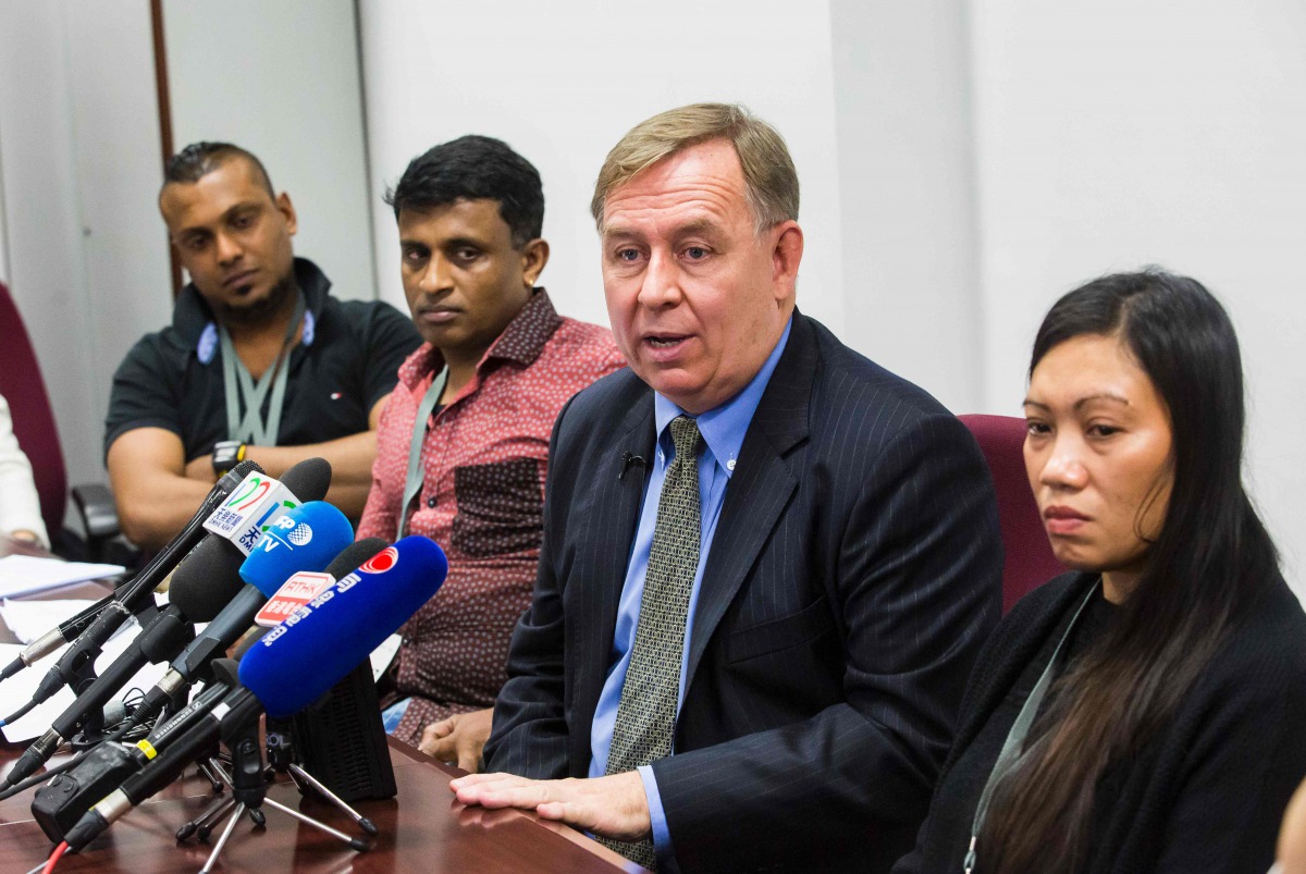 Sri Lankan refugees Supun Thilina Kellapatha (left) and Ajith Puspa (second left), Filipino refugee Vanessa Rodel (right), and their lawyer Robert Tibbo at the Legislative Council of Hong Kong, yesterday.