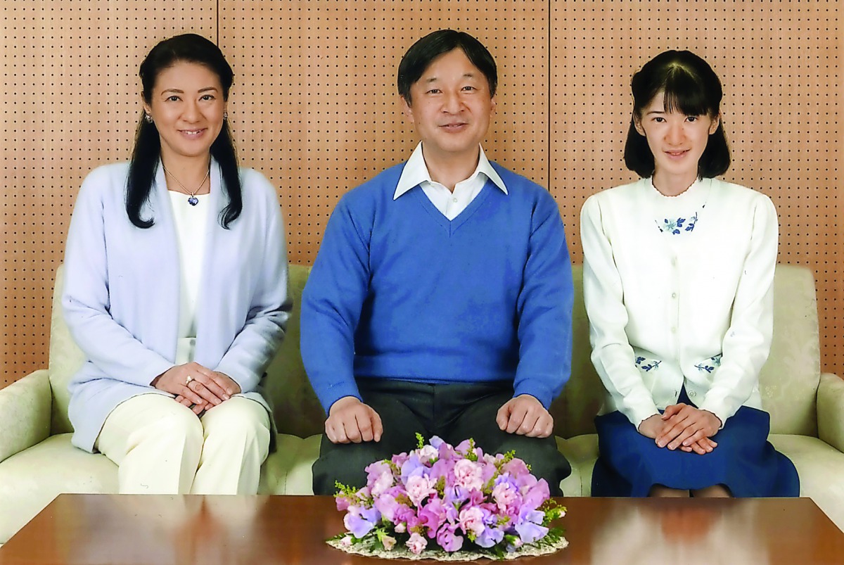 Crown Prince Naruhito (centre) posing with Crown Princess Masako (left) and their daughter Princess Aiko at Togu Palace, in Tokyo. 