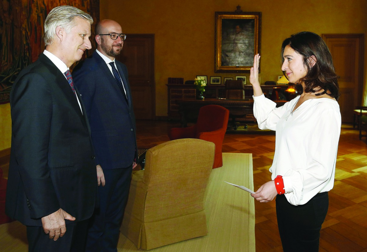 (From L) King Philippe - Filip of Belgium, Belgian Prime Minister Charles Michel stand as Zuhal Demir gestures during the oath ceremony of Demir as new State secretary for the fight against poverty, equal opportunities, disabled, science politic and big c