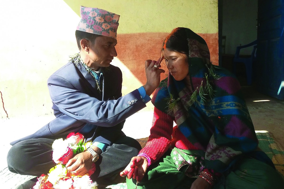 In this photograph taken on February 23, 2017, Nepalese prisoners Dilli Koirala (L) and Mimkosha Bista take part in their wedding ceremony inside Kalikot District Jail in Kalikot, some 388km from Kathmandu. A man and a woman each serving time for killing 